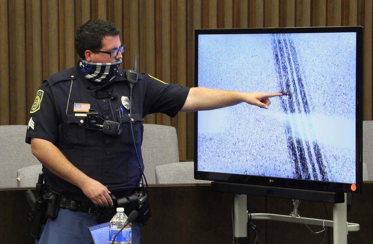 Sgt. Joshua Bailey of the Columbus Police Department testifies Tuesday morning about photographs he took of tire marks in the Columbus Civic Center parking lot. 09/14/2021
