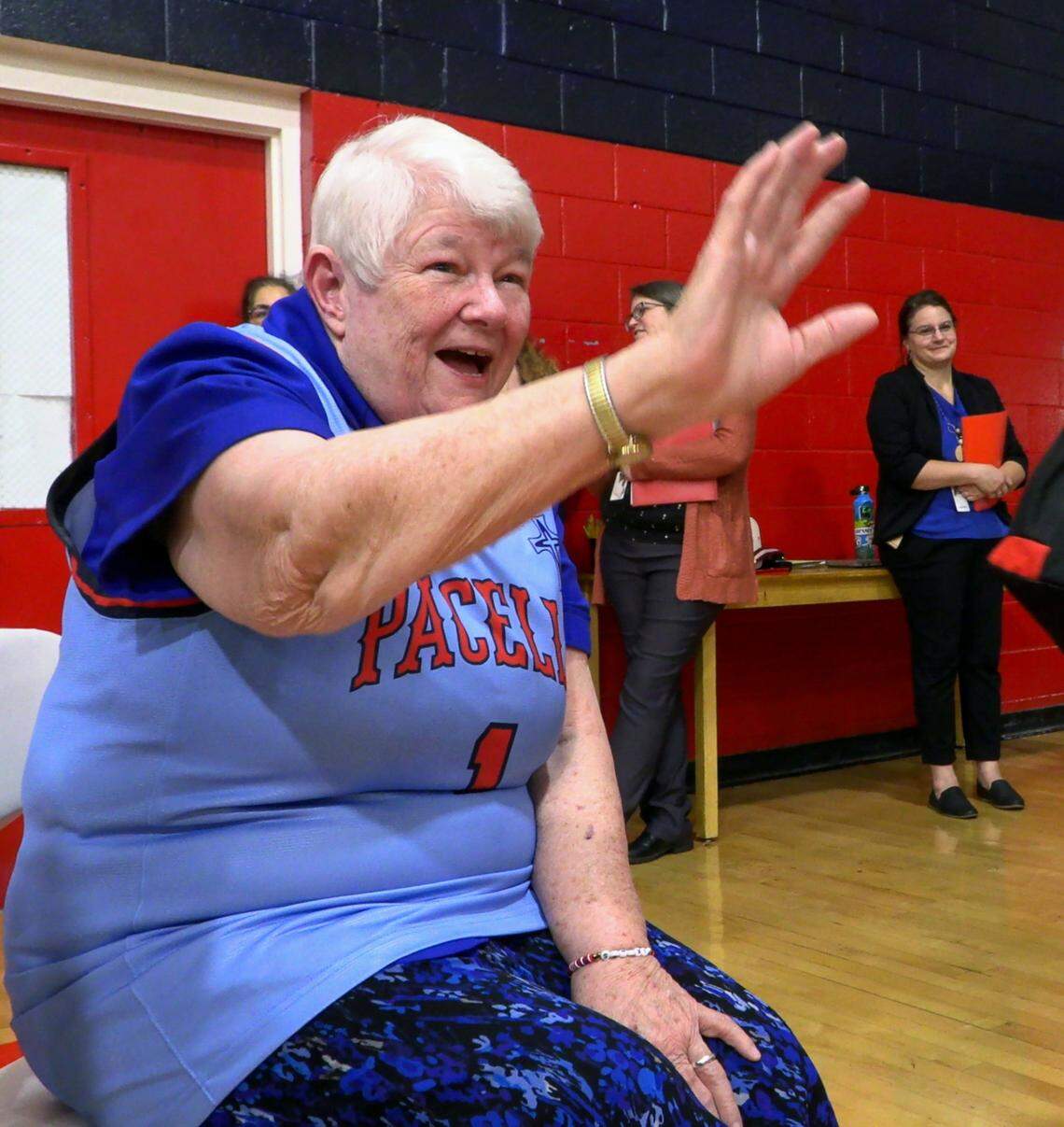 Sister Pat Thompson says goodbye to school children after a ceremony at St. Anne-Pacelli Catholic School on Dec. 9, 2024, honoring her and Sister Margaret Downing, both with the Sisters of Mercy. The two are retiring, and the school unveiled a special basketball jersey in their honor. 12/09/2024