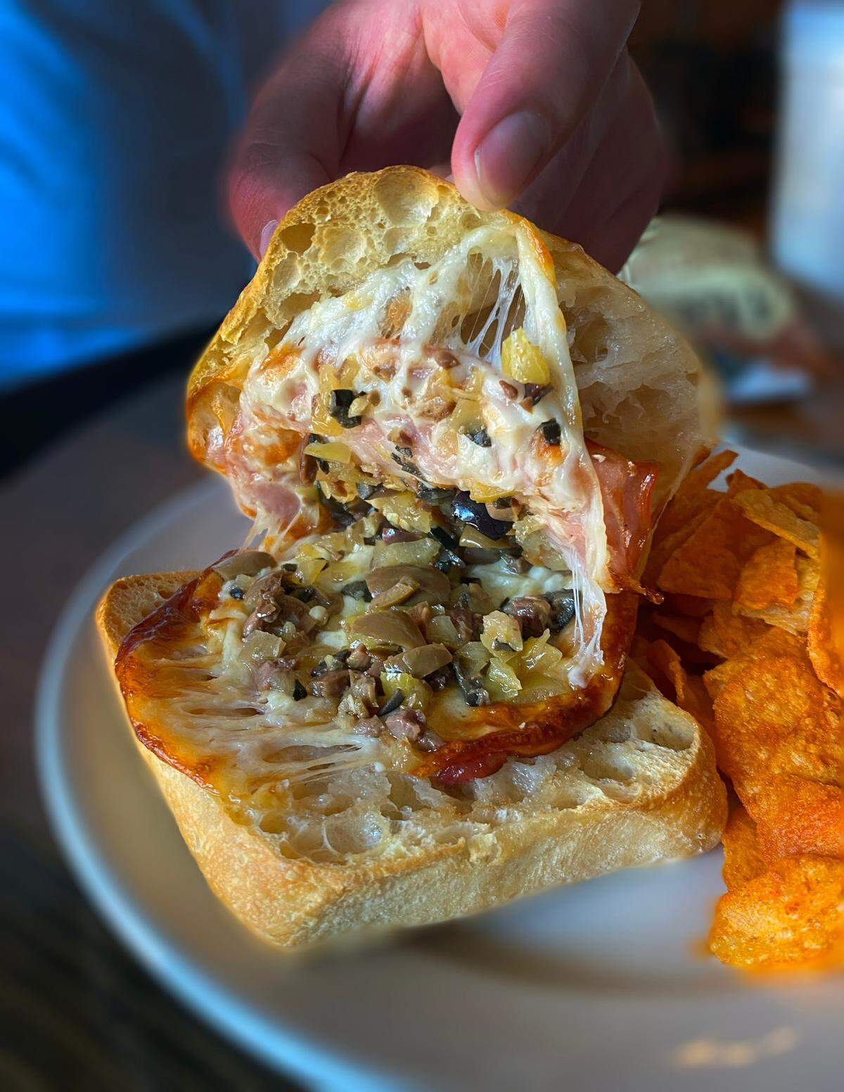 Ledger-Enquirer reporter Kelby Hutchison ordered the Muffaletta sandwich (Genoa Salami, Mortadella, Olive Mix, Provolone, and Swiss) on Ciabatta bread and a side of chips at The Tower & My Boulánge in Columbus, Georgia.