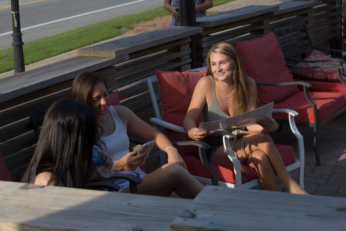 Customers browse a menu at Jarfly, 1358 13th Street, in Columbus, Georgia, on June 24, 2021.