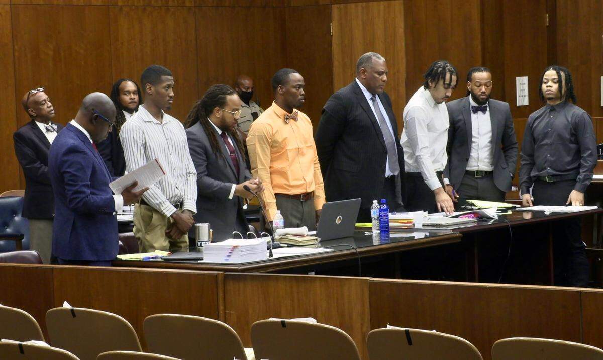 Defense attorneys and their clients await the return of the jury after a break in the proceedings Wednesday morning. 03/23/2022