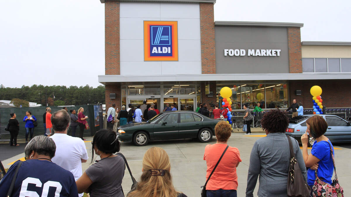 In this 2015 photo, people wait in line Thursday morning for the new ALDI store at 6301 Veterans Parkway in Columbus to open for the first time. ALDI is opening a new location in midtown Columbus.