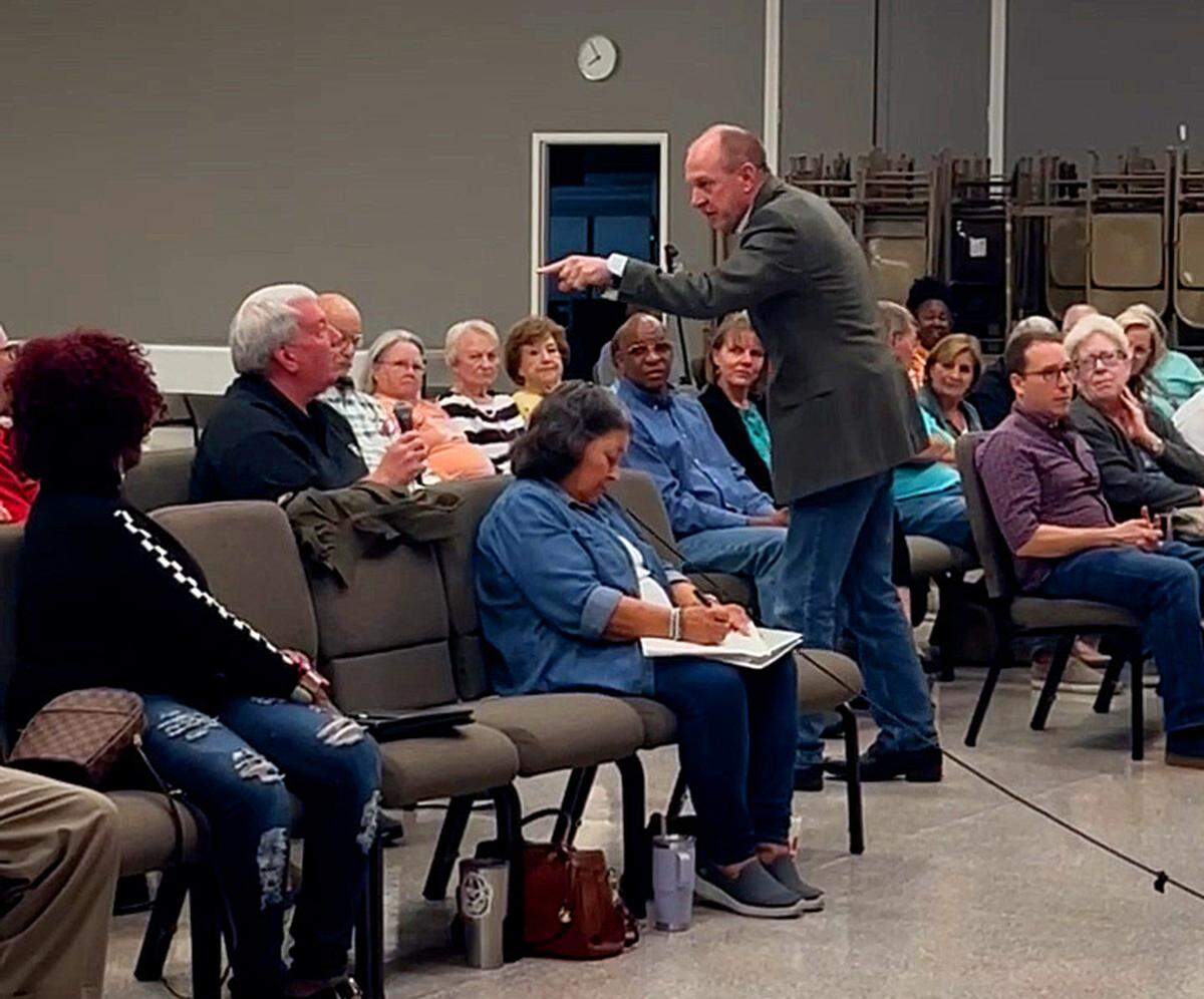 Dave Erickson, advisor and general contractor for or Wizer Home Builders, standing, responds to a local resident’s comments during a town hall meeting on Nov. 12 at Wynnton Methodist Church about the company’s request to rezone the property at 5201 Macon Rd. in Columbus, Georgia.