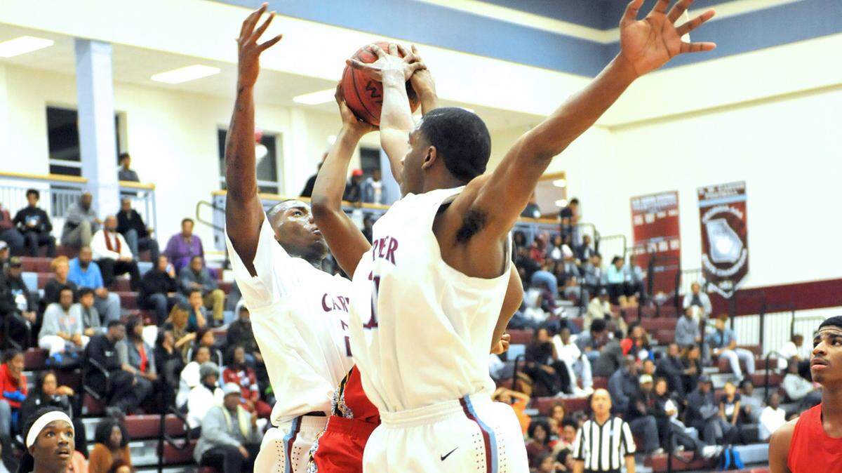 Hardaway's Keionte Mims sandwiched between Carver's Jawon Pass and Rahmir Nelson as he attempts a shot late in the 2nd period of the game Friday night