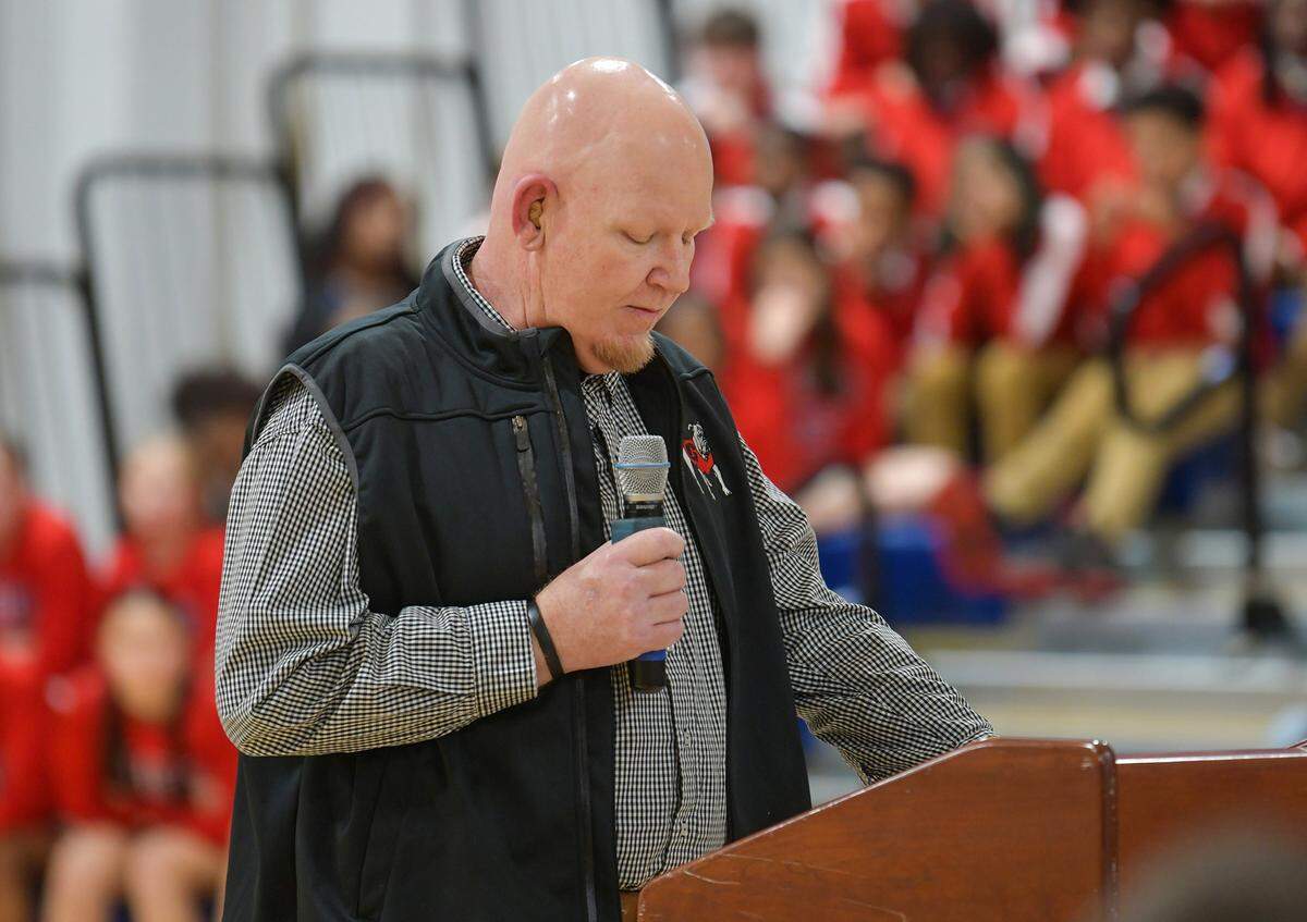 Coach Jay Wilson of Veterans Memorial Middle School in Columbus, Georgia greets guests, family and dignitaries for the dedication ceremony naming the school gymnasium’s court in his honor. 01/24/2024