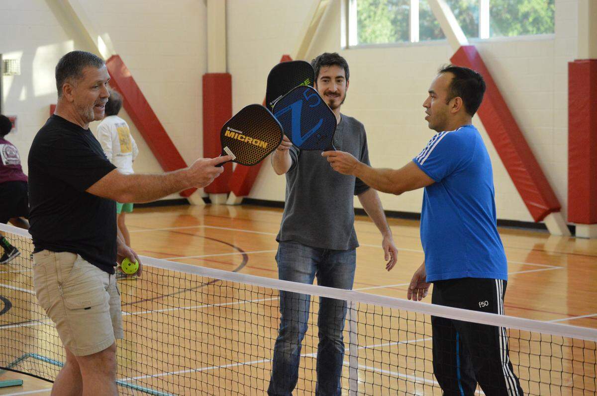 Pickle ball players celebrate a good match.