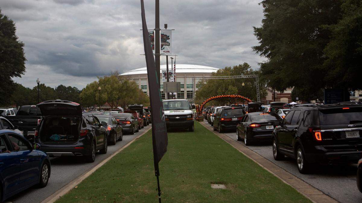 Cars wrap around the Civic Center parking lot during the Spooktacular Trunk or Treat event on Sunday, Oct. 25, 2020 in Columbus.