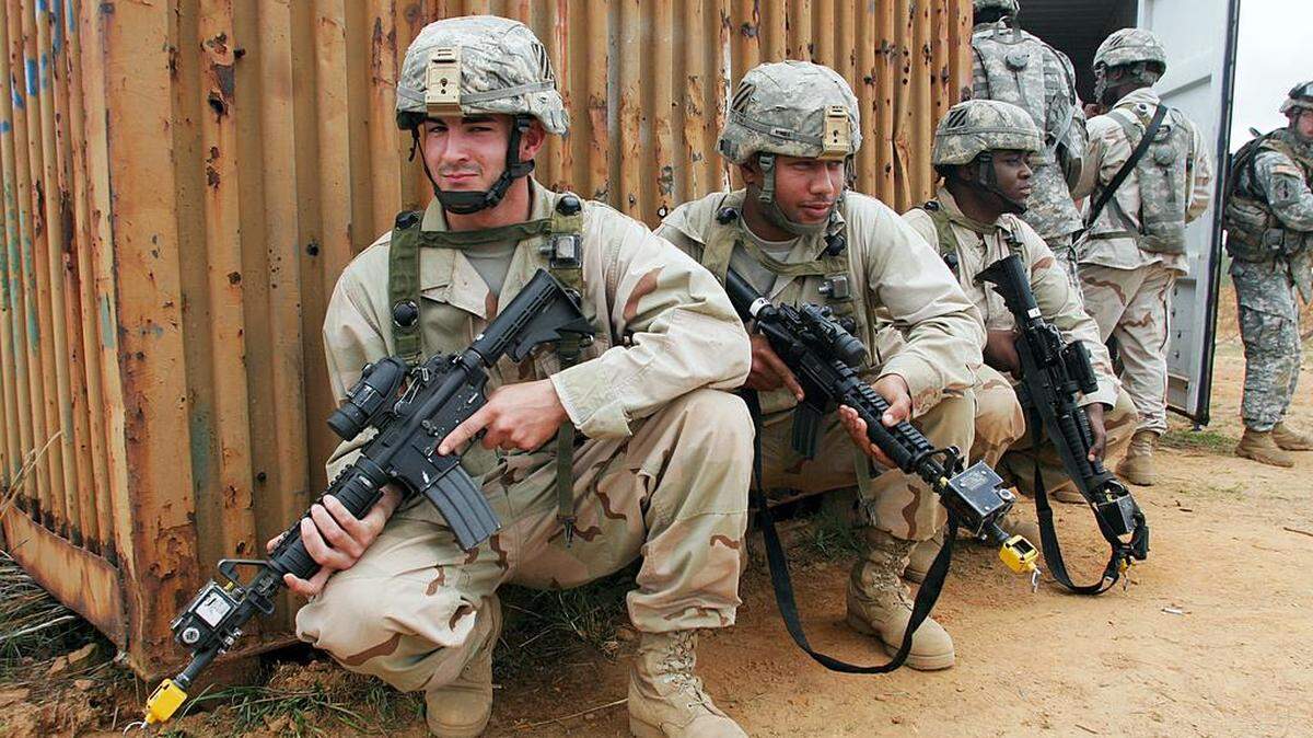 FILE -- Soldiers in the 3rd Squadron 1st Cavalry Regiment, 3rd Heavy Brigade Combat Team, 3rd Infantry Division carry out a combat exercise in a mock Iraqi village during the 3rd HBCT Hammer Focus training at Fort Benning.