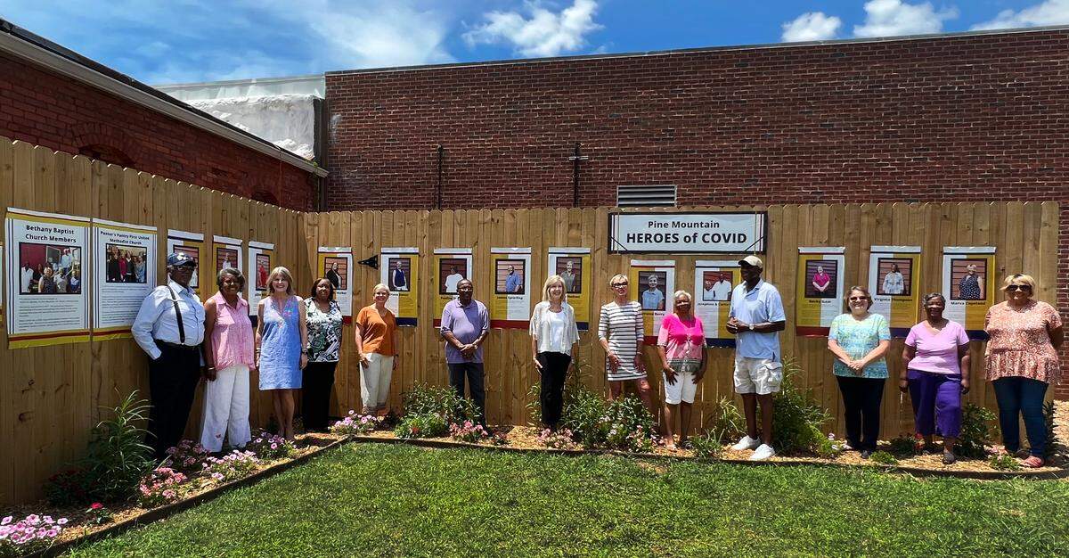 Covid Heroes stand in front of the Chipley Historical Center’s new garden exhibit honoringPine Mountain, Georgia heroes who combated food insecurity during the coronavirus pandemic.