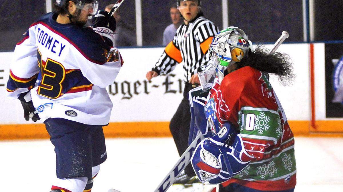 Columbus' Shannon Szabados blocking the shot by Peoria's Connor Toomey early in the 2nd period of the game Friday night a the Civic Center
