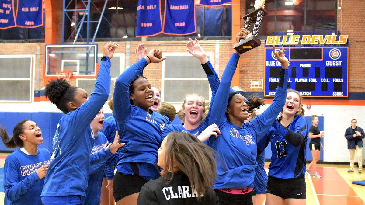 The Columbus Blue Devils celebrate their win over the Northside Patriots for the Region 1-AAAA volleyball championship Monday, October 15, 2018