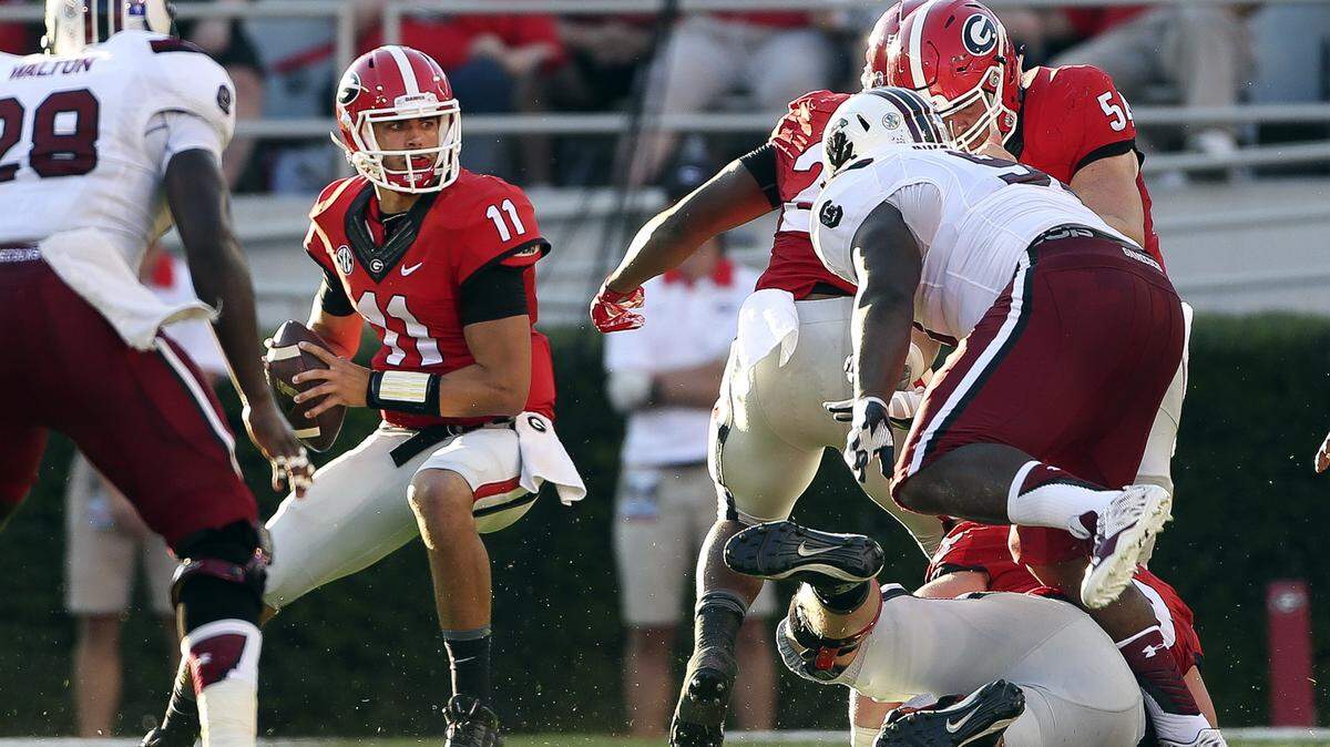 JOHN BAZEMORE/Associated PressGeorgia quarterback Greyson Lambert (11) looks for an open receiver under pressure from the South Carolina defense Saturday in Athens., Ga. Georgia won 52-20.
