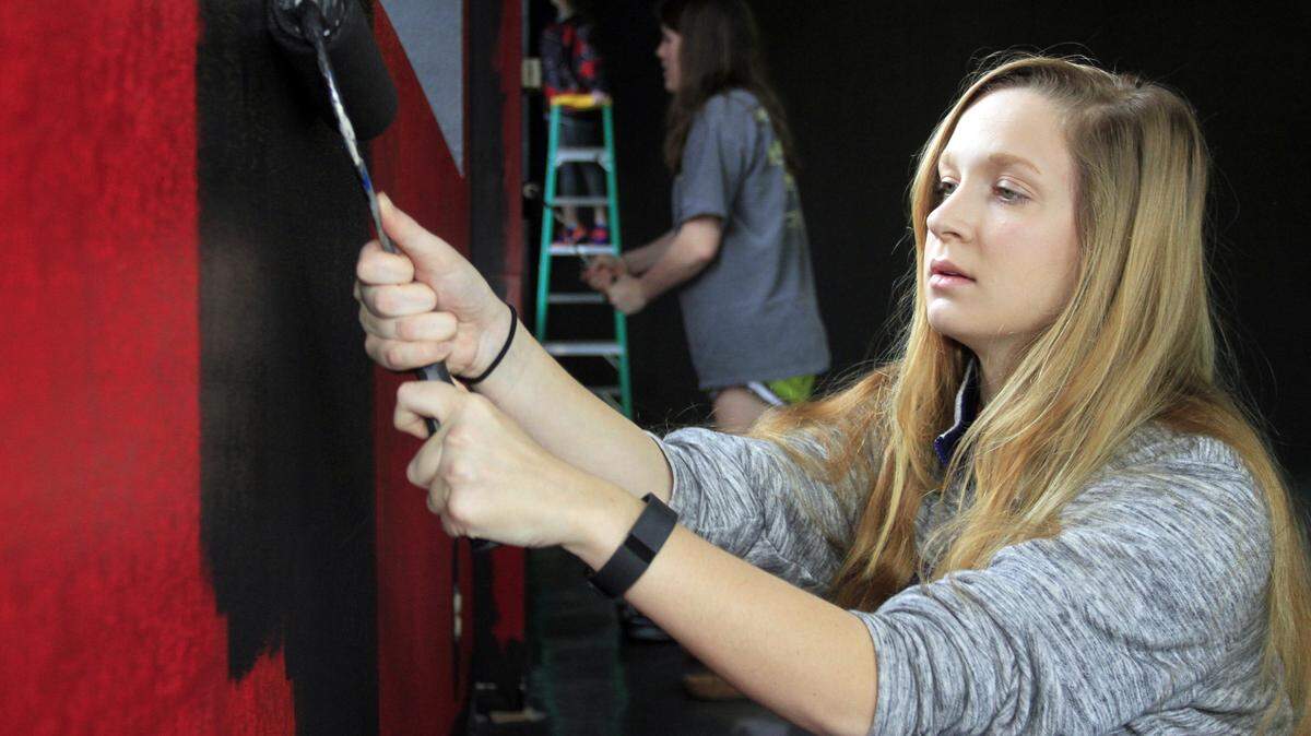 Brooke Rumford, front, and Molly McCune paint the interior of a large space in downtown Columbus for opening a new downtown ministry called Second Story. It is aimed at college students and young professionals. Below, Chris Scrivner, front, and Claire Maddox paint the same space.