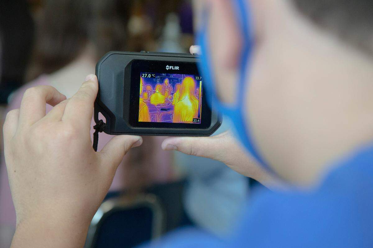 A student aims an infrared camera at the classroom in Columbus High School on August 25, 2021 in Columbus, Ga. The camera was given to CHS science teacher Laura Solomons by NASA during her flight.
