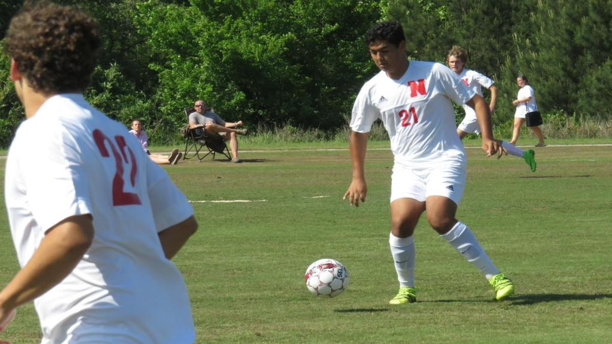 Northside’s Ameen Elrhalami (21) works the ball upfield while teammate Matt Shehane (22) runs to his left in the Patriots’ playoff game against Thomson on April 26, 2017.