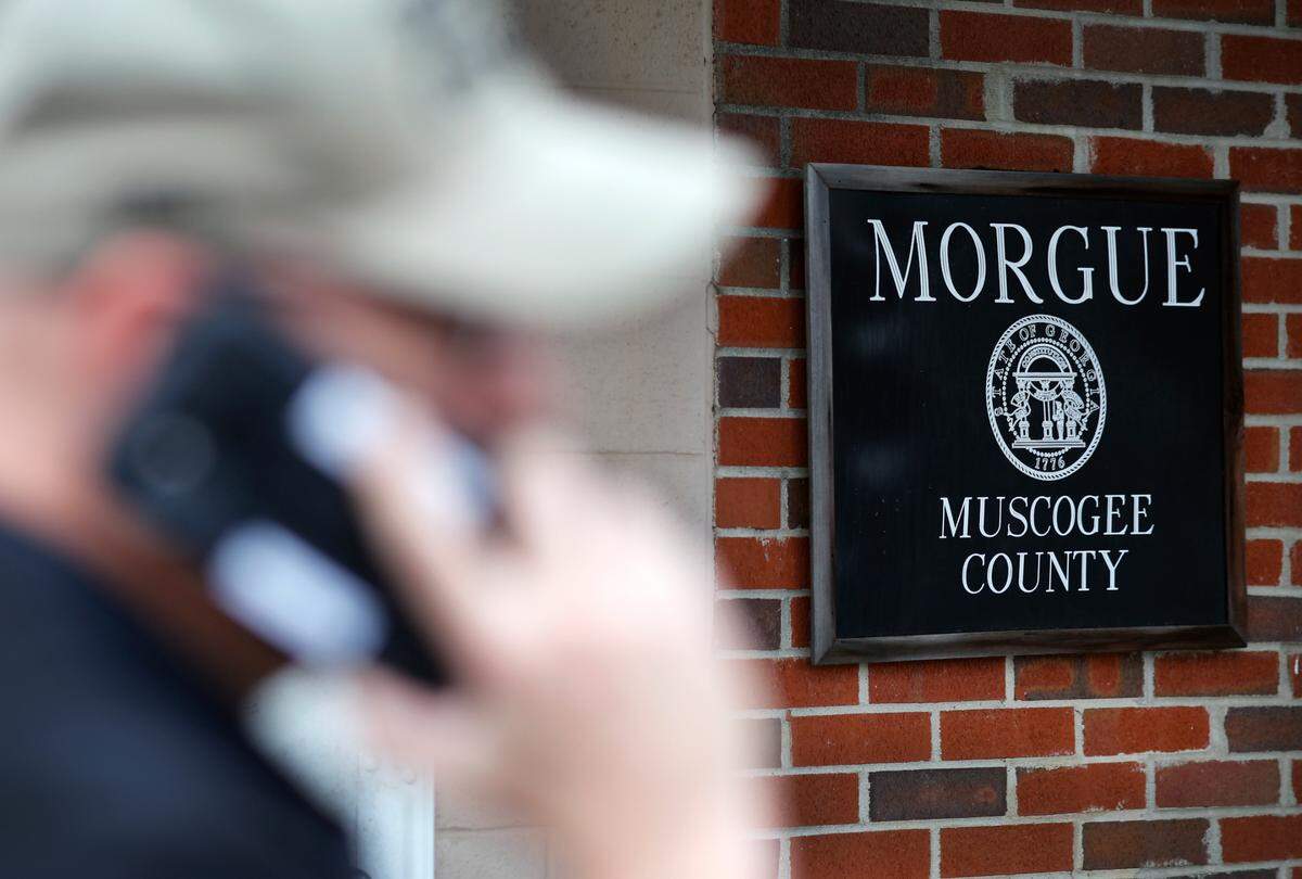 Ben Saxon, a deputy coroner in Muscogee County, Georgia, makes a call outside of the morgue. 03/10/2023