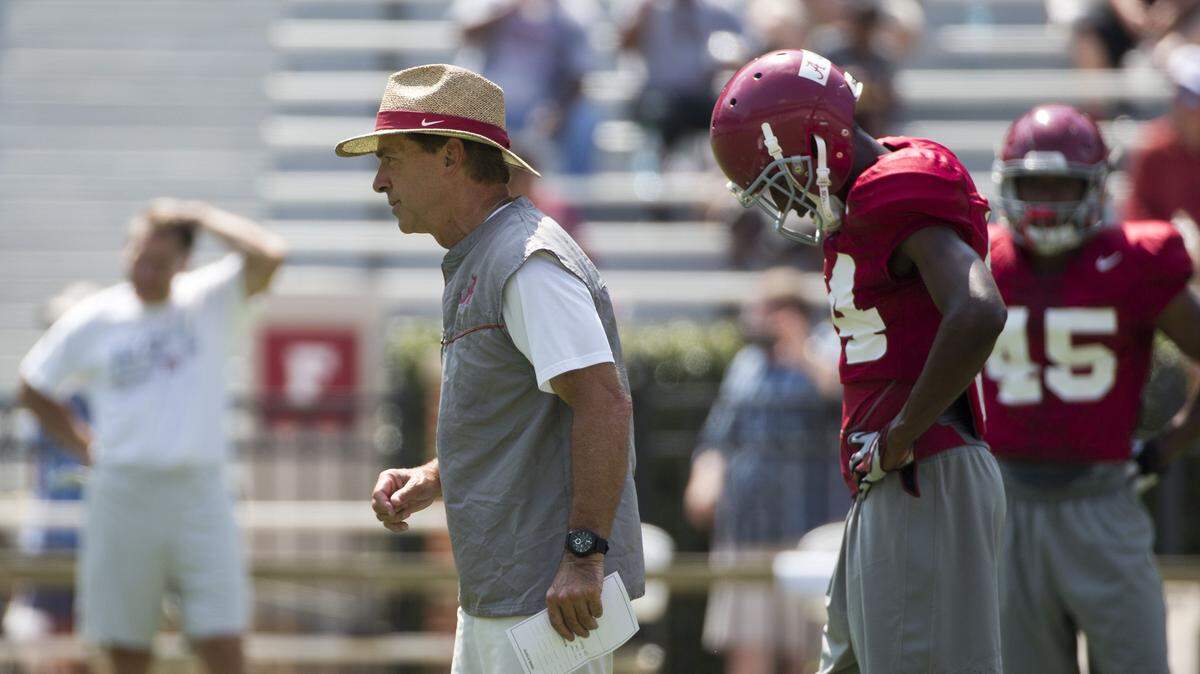 Alabama coach Nick Saban, front left, runs drills during an NCAA college football practice, Sunday, Aug. 9, 2015, in Tuscaloosa, Ala. (AP Photo/Brynn Anderson)
