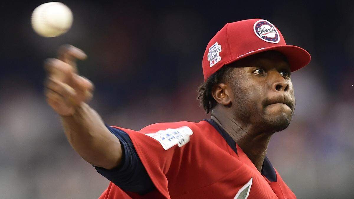 World Team Touki Toussaint, of the Atlanta Braves works against the U.S. Team during the eighth inning All-Star Futures baseball game, Sunday, July 15, 2018, at Nationals Park, in Washington, D.C.