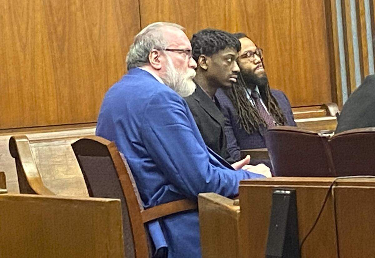 Left to right, attorney Mark Shelnutt, client Corey Troupe and attorney William Kendrick listen as Elysia Cooley testifies.