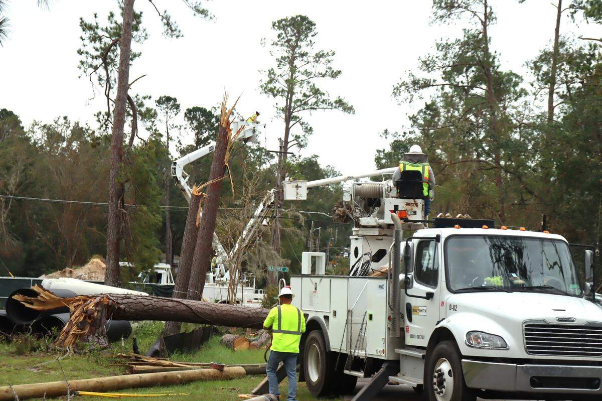 Workers remove trees and fix broken power lines in Valdosta, Georgia to help restore power to Georgia’s electric grid. Oct. 4, 2024