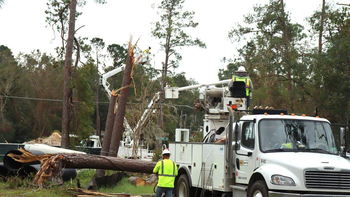 Workers remove trees and fix broken power lines in Valdosta, Georgia to help restore power to Georgia’s electric grid. Oct. 4, 2024