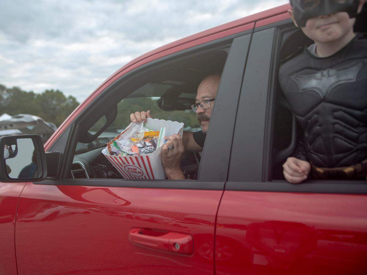 The Coze family displays the candy gathered at the Spooktacular Trunk or Treat event on Sunday, Oct. 25, 2020 at the Civic Center in Columbus.