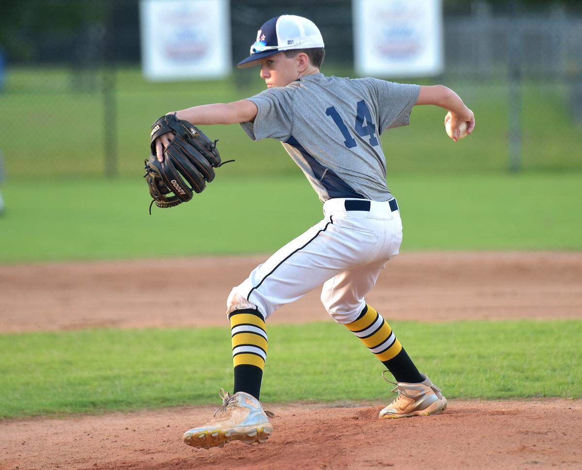 Collin Freiberg pitches at practice Thursday evening as the team readies for a trip to the state tournament.
