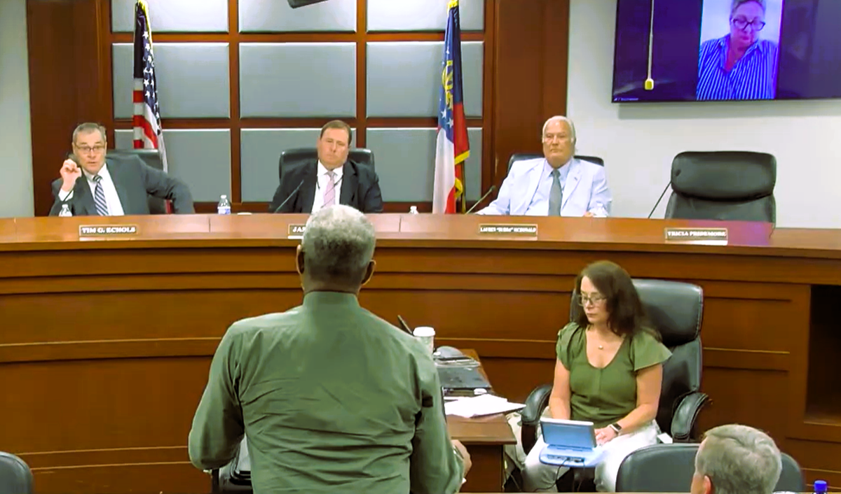 Commissioner Tim Echols and public witness Sebron Spivey discuss biomass at the June 23 Georgia Power Integrated Resource Plan hearing.