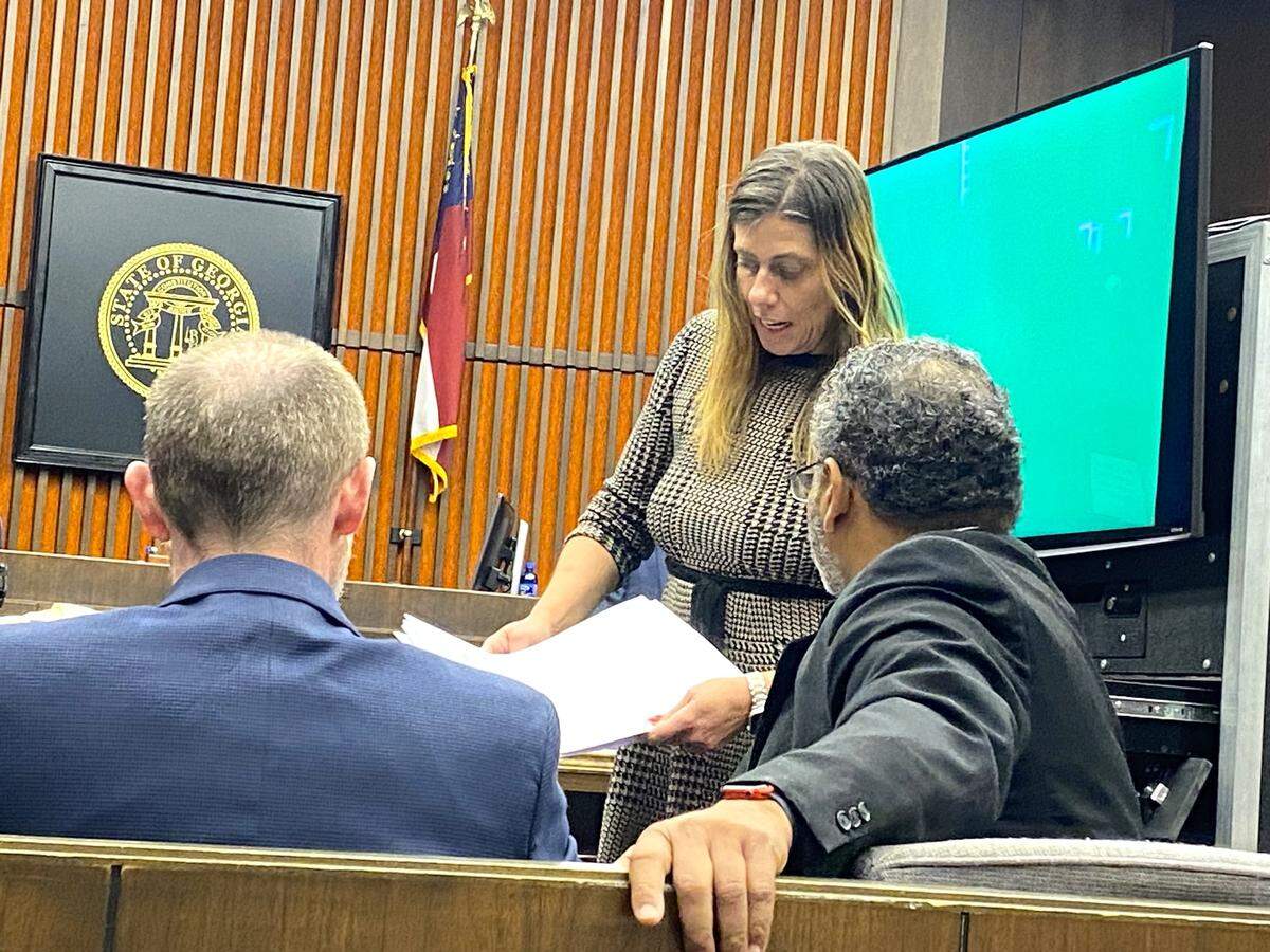 Emmanuel Truitt’s defense attorney Sirena Saunders discusses evidence with prosecutor Ray Daniel.