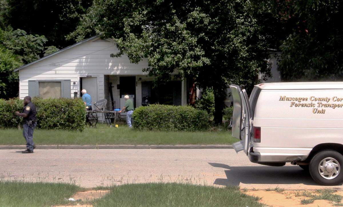 Muscogee County Coroner officials enter the home of Stanford Jones at 427 Mellon Street after he was found dead in his living room early Friday morning.