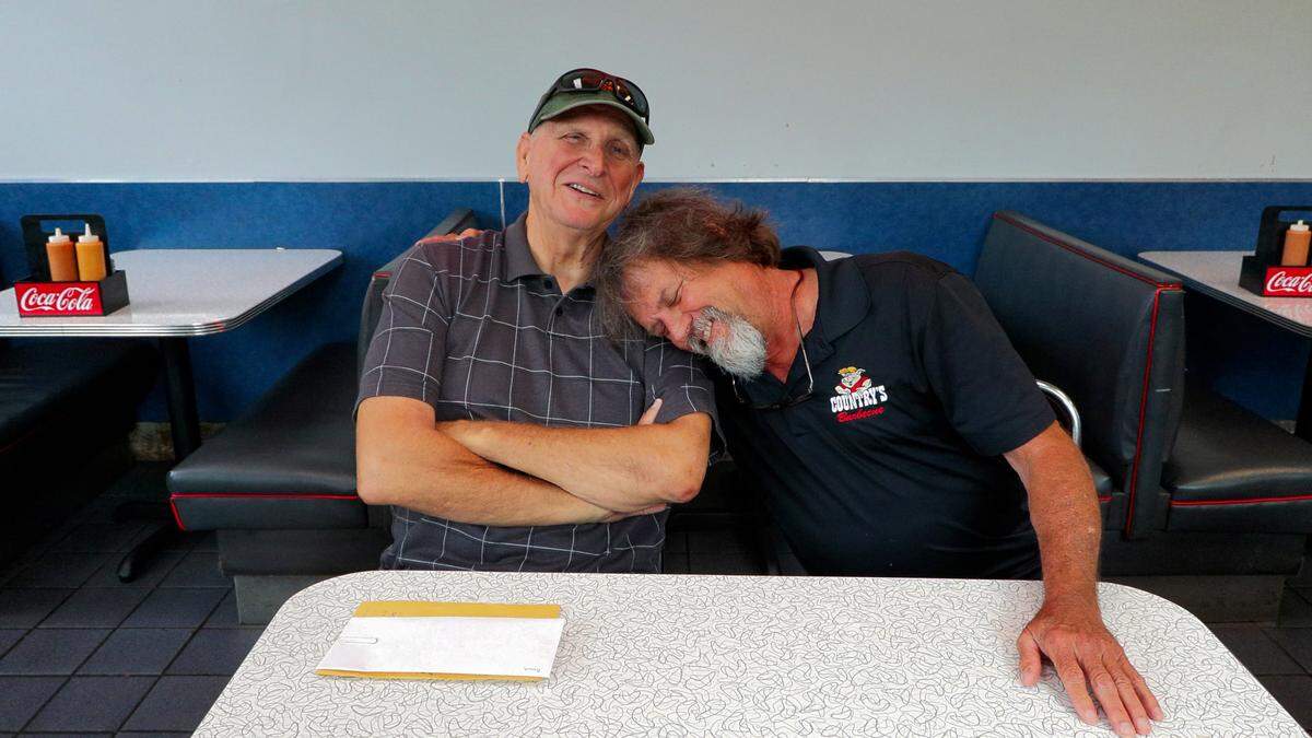 Miracle Riders Brad Hansen, left, and Scott Ressmeyer joke before an April 27, 2026, interview about the Miracle Ride.