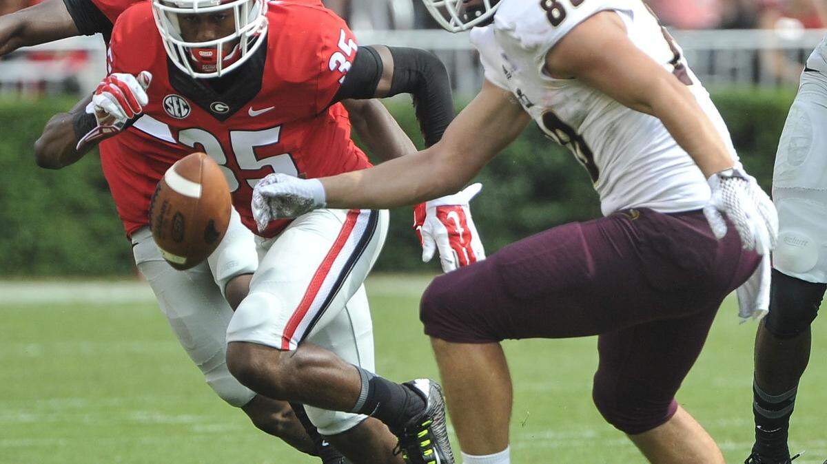 Louisiana Monroe tight end Harley Scioneaux (88) fumbles as Georgia cornerback Aaron Davis (35) and safety Dominick Sanders (24) defend during the second half of an NCAA college football game, Saturday, Sept., 5, 2015, in Athens, Ga. Georgia won 51-14.(AP Photo/John Amis)