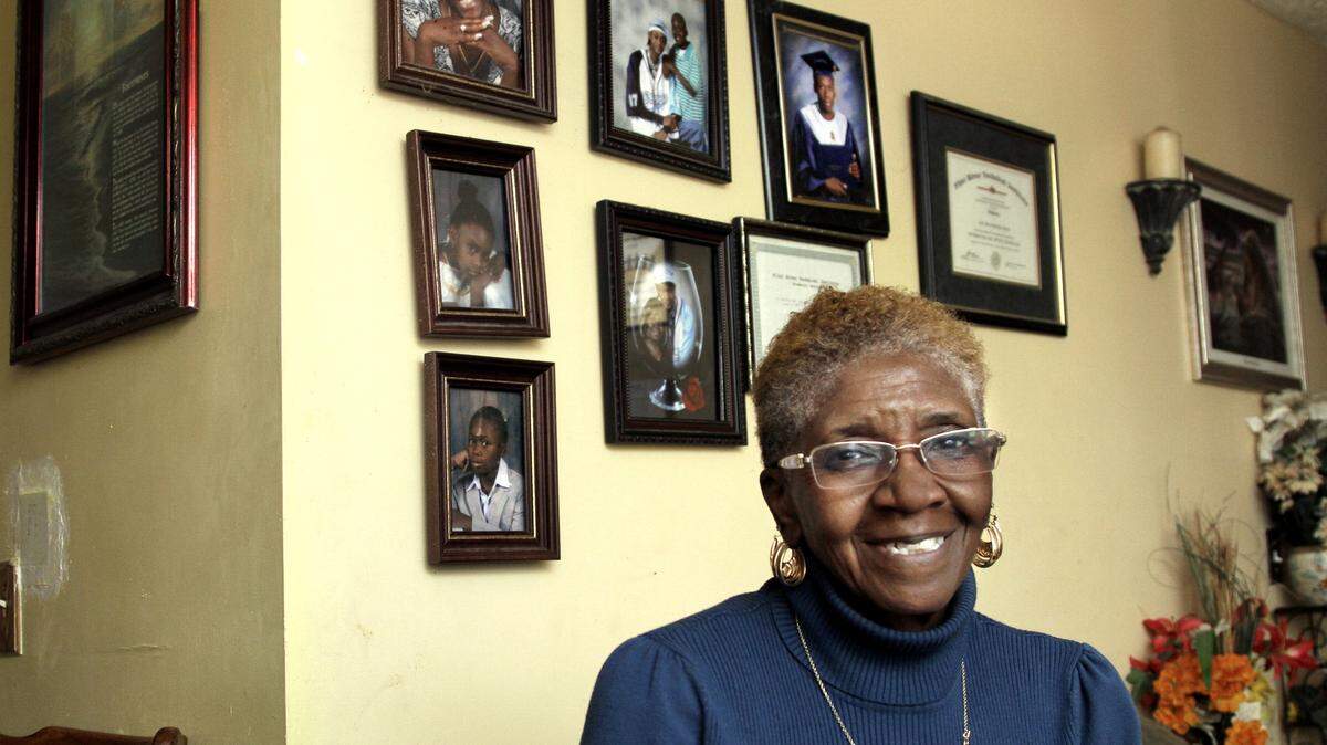 Joe Ann Howe has raised her grandson and granddaughter, pictured on the wall, since they were young children.ROBIN TRIMARCHI/rtrimarchi@ledger-enquirer.com