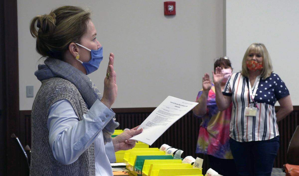 Auditors are sworn in by Nancy Boren, director of elections and registration for Muscogee County, far left, Friday morning. Bipartisan teams of Democrats and Republics began a manual ‘audit’ of Columbus’ 80,000-presidential votes Friday morning in Columbus Council Chambers at the City Service Center in Columbus, Georgia.