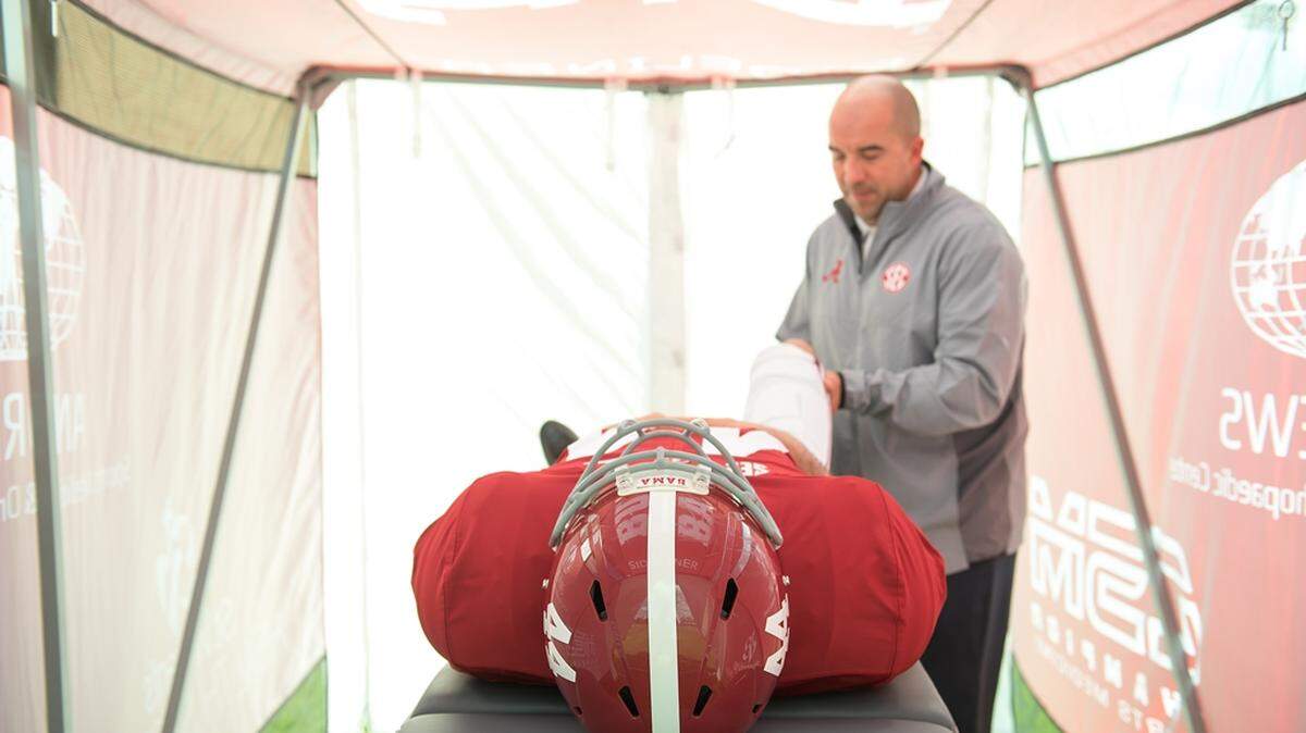 Jeff Allen, director of sports medicine at UA, demonstrates an exam inside the SidelinER.