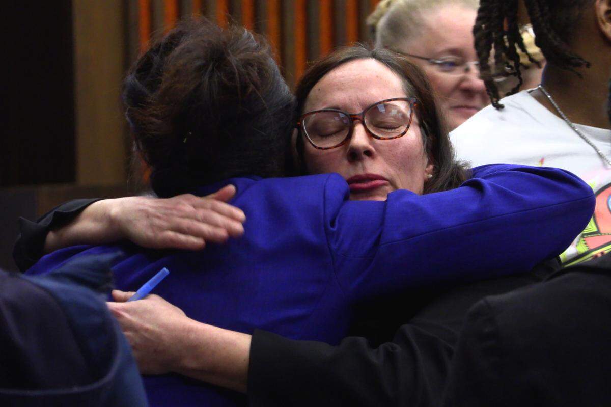 Assistant District Attorney Robin Anthony, facing camera, hugs Wanda Banks-Rookard, the mother of Joseph “Jo Jo” Banks, after the sentence hearing Wednesday where Antonio Bernard “Tony” Willis was sentenced to 30 years in prison. 01/04/2023
