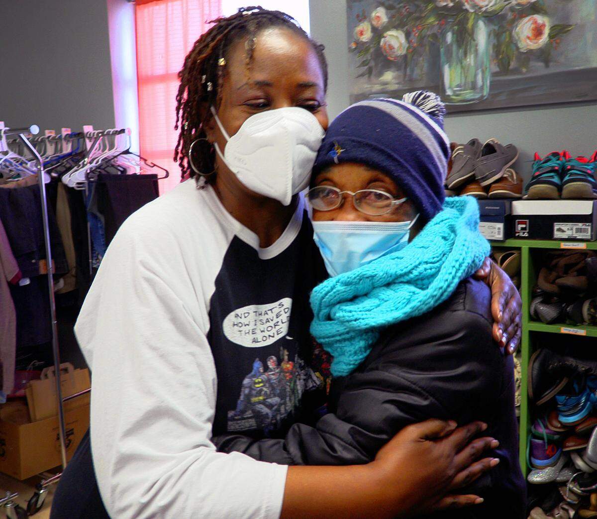 Renae Dickerson, left, director of the Love & Kindness Community Clothing Bank at 1721 13th Avenue in Columbus, Georgia, gets a hug from Carolyn Sims after helping Sims select some clothing to take home.
