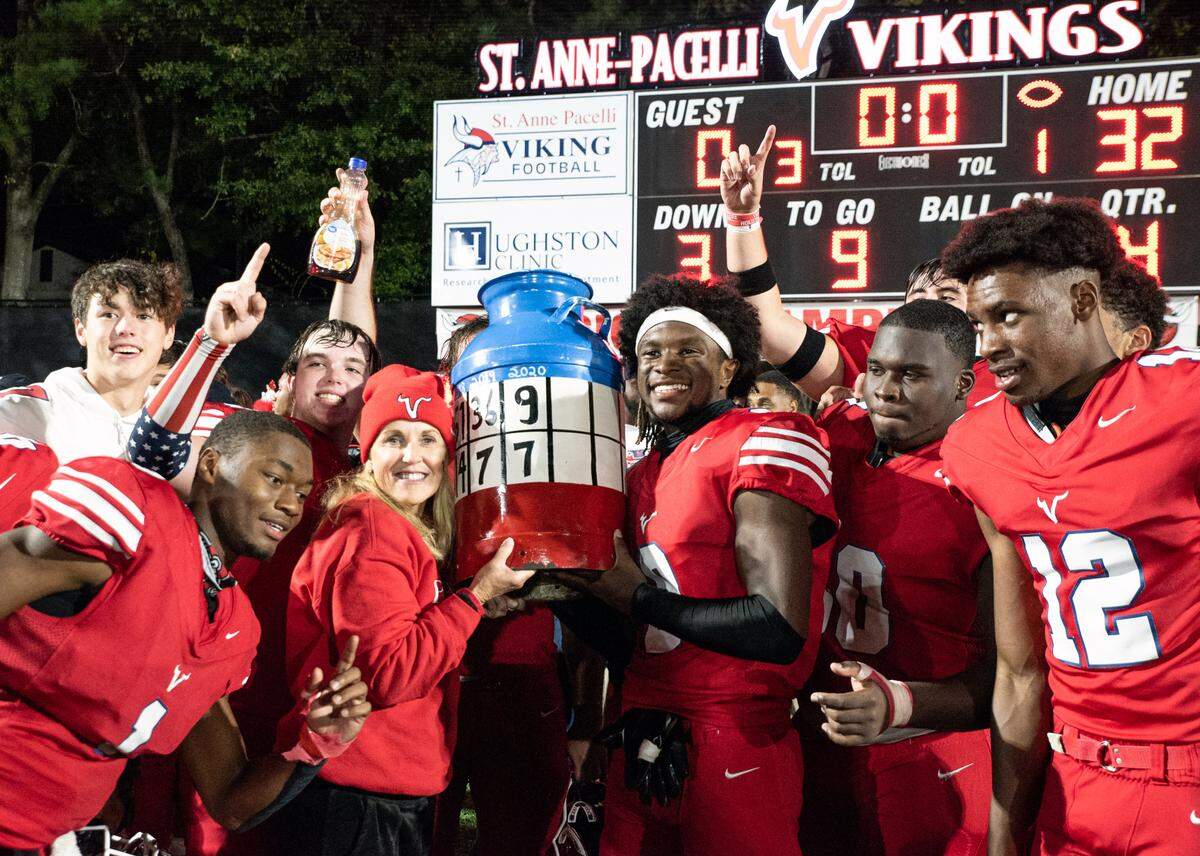 Ronie Collins, president of St. Anne-Pacelli Catholic School in Columbus, Georgia, poses for a photograph with players from Pacelli’s football team after they defeated rival Brookstone in 2021 to claim the Broochelli Jug. Collins has recently announced her retirement. 02/28/2024