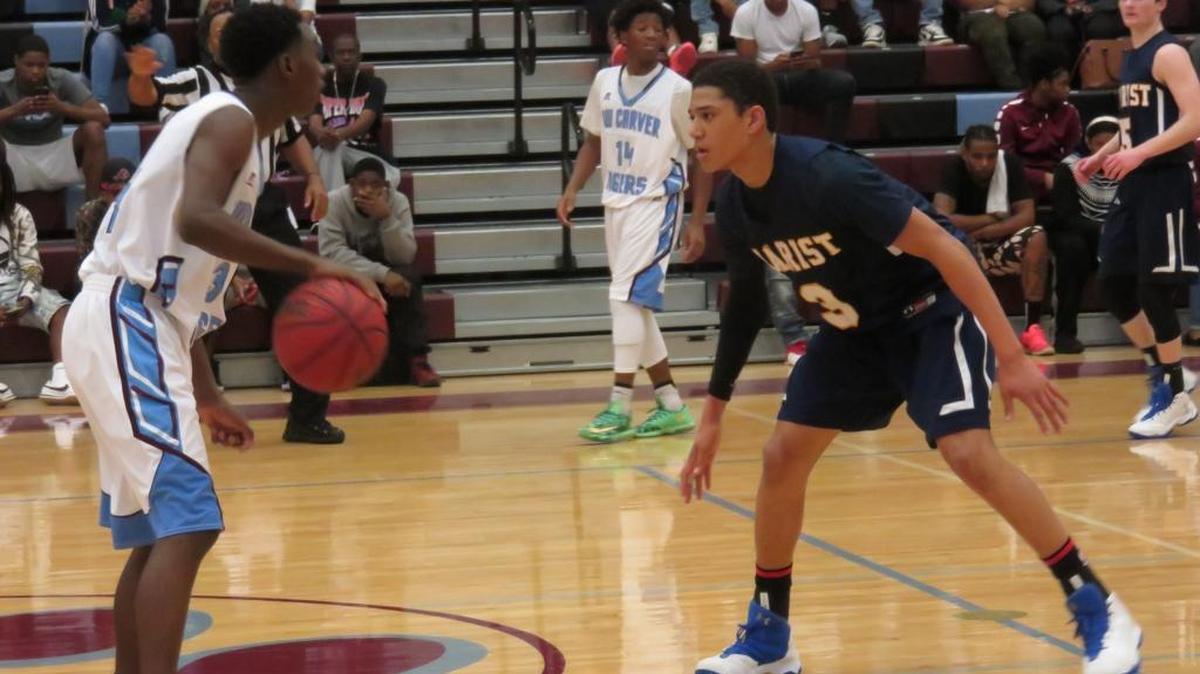 Rodney Battle looks for an open teammate against Marist in the second round of the playoffs at Carver High School on February 23, 2017.
