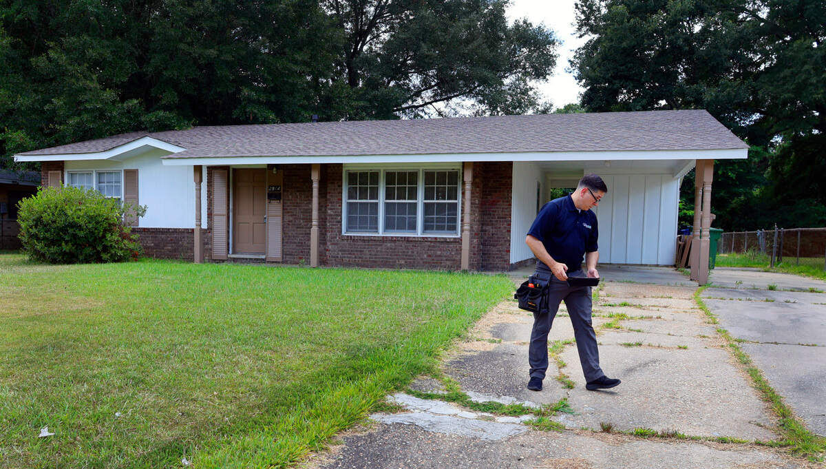 Ben York, a home inspector with Pillar to Post Home Inspectors, inspects a home in Columbus’ Oakland Park neighborhood.