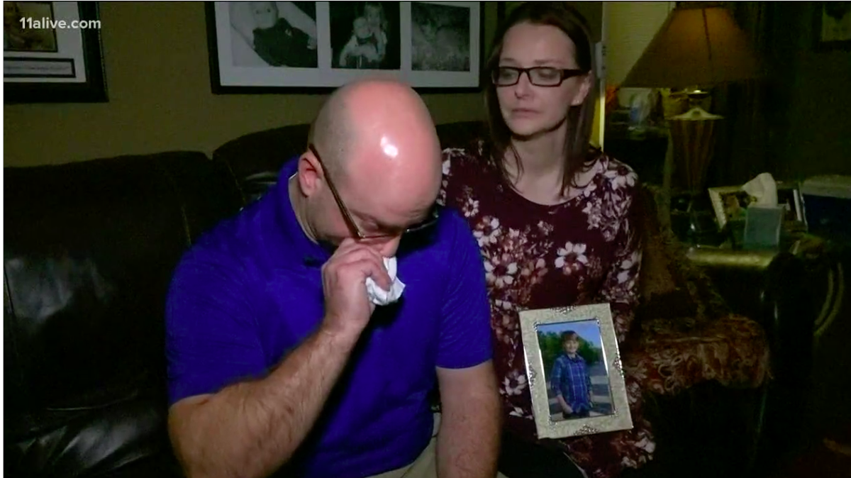 Braden Stevenson, a Covington, Ga., 12-year-old, died when a runaway car smashed through his garage while he was looking for a hamster before Thanksgiving. Another boy,  Lucas McWilliams, was seriously injured. Pictured are Braden’s father and stepmother, according to WXIA.