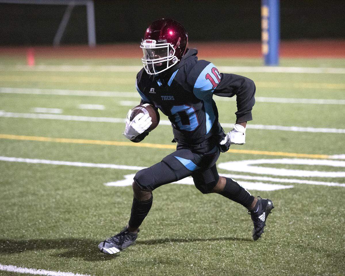 Carver’s Kam Venisee returns the opening kickoff from the 10-yard line past the 40-yard line in the first first quarter of the GHSA Class AAAA first-round state playoff game against Woodward Academy on Friday night, November 9, 2018 at Kinnett Stadium.