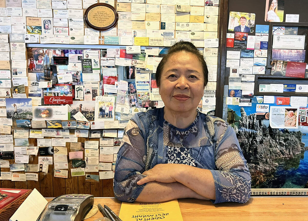 Bun Im Chong poses for a photo inside Ok Sun Oriental Restaurant in Columbus, Georgia. Ok Sun Oriental Restaurant will open to serve loyal customers in Columbus for one final week as it prepares to permanently this year.