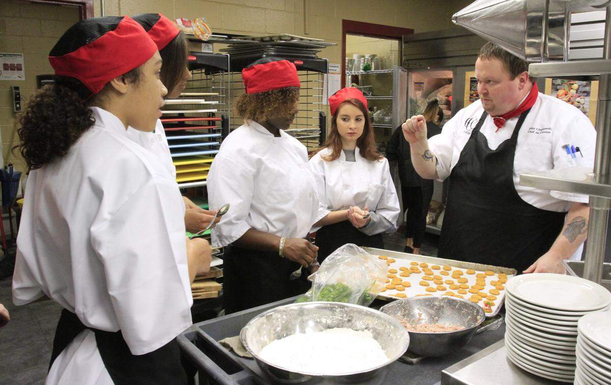 Chef John Chapiewski, right, who teaches culinary arts and hospitality at Central High School in Phenix City, works in this 2015 photo with students preparing appetizers to serve guests at Central High’s bistro, “The Brick.”