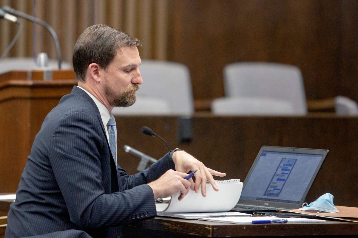 Deputy Attorney General John Fowler looks through notes during a pretrial motions hearing for suspended Muscogee County District Attorney Mark Jones, on Oct. 21, 2021, at the Government Center in Columbus, Ga.