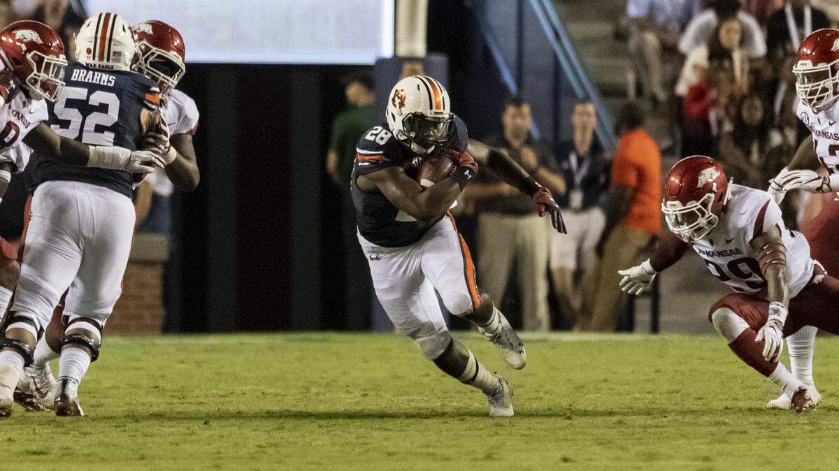 Auburn running back JaTarvious Whitlow (28) gets into the open field against Arkansas during the first half of thier game Saturday in Auburn, Ala.