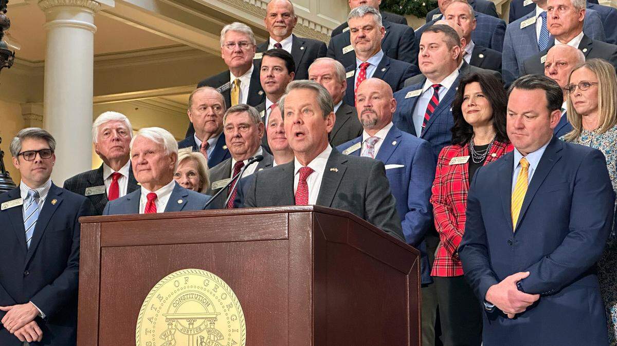 Georgia Gov. Brian Kemp, flanked by Republican lawmakers, speaks Monday, Dec. 4, 2023, at the Georgia Capitol in Atlanta. (AP Photo/Jeff Amy)