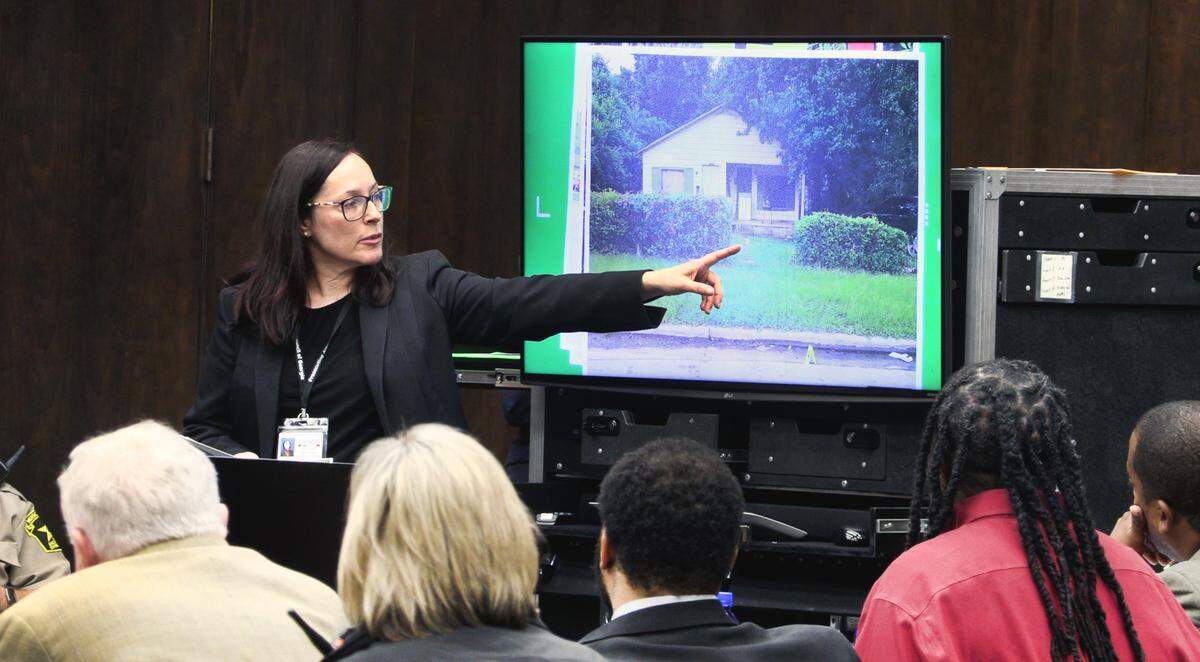 Assistant District Attorney Robin Anthony shows photographs of the crime scene.