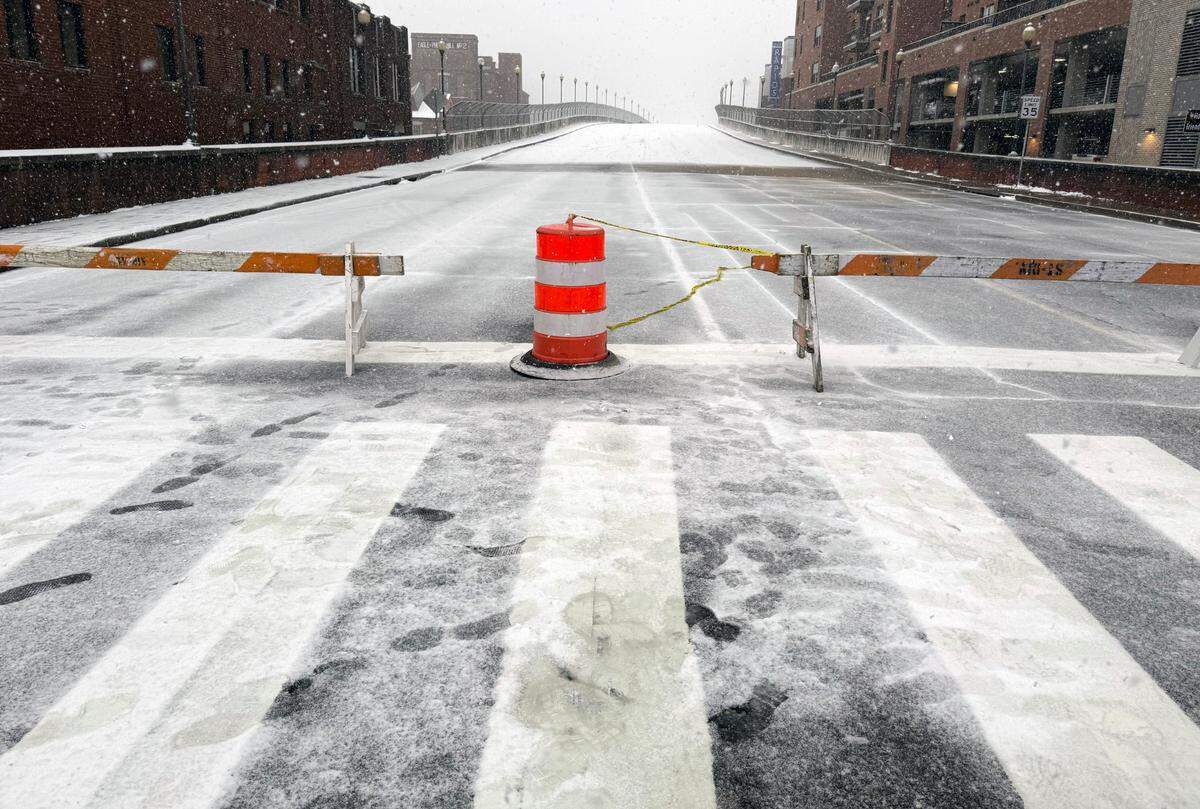 A barricade at the intersection of Broadway and 13th Street in downtown Columbus, Georgia prevents motorist from crossing the bridge into Phenix City, Alabama.
