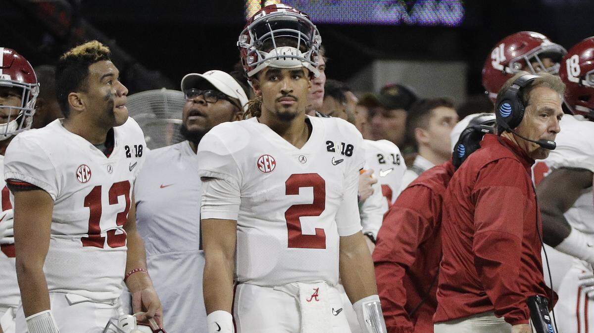 Alabama’s Jalen Hurts (2) is seen on the bench with Tua Tagovailoa (13) head coach Nick Saban during the second half of the NCAA college football playoff championship game against Georgia Monday, Jan. 8, 2018, in Atlanta